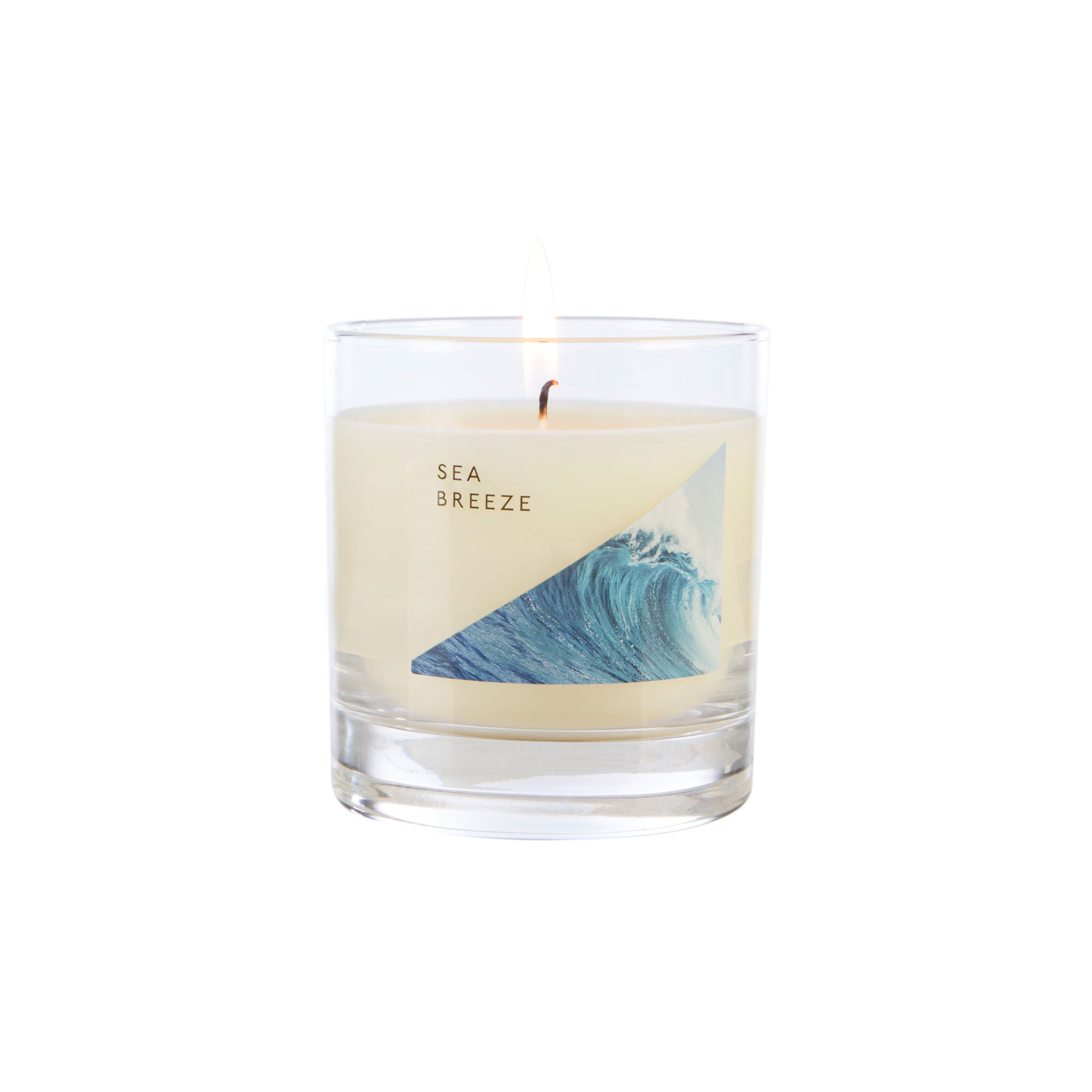 Wax Lyrical Made In England Sea Breeze Medium Tin Candles. A refreshing fragrance bringing watery notes to your home. A floral heart, fresh figs and woody notes, amber and musk.
