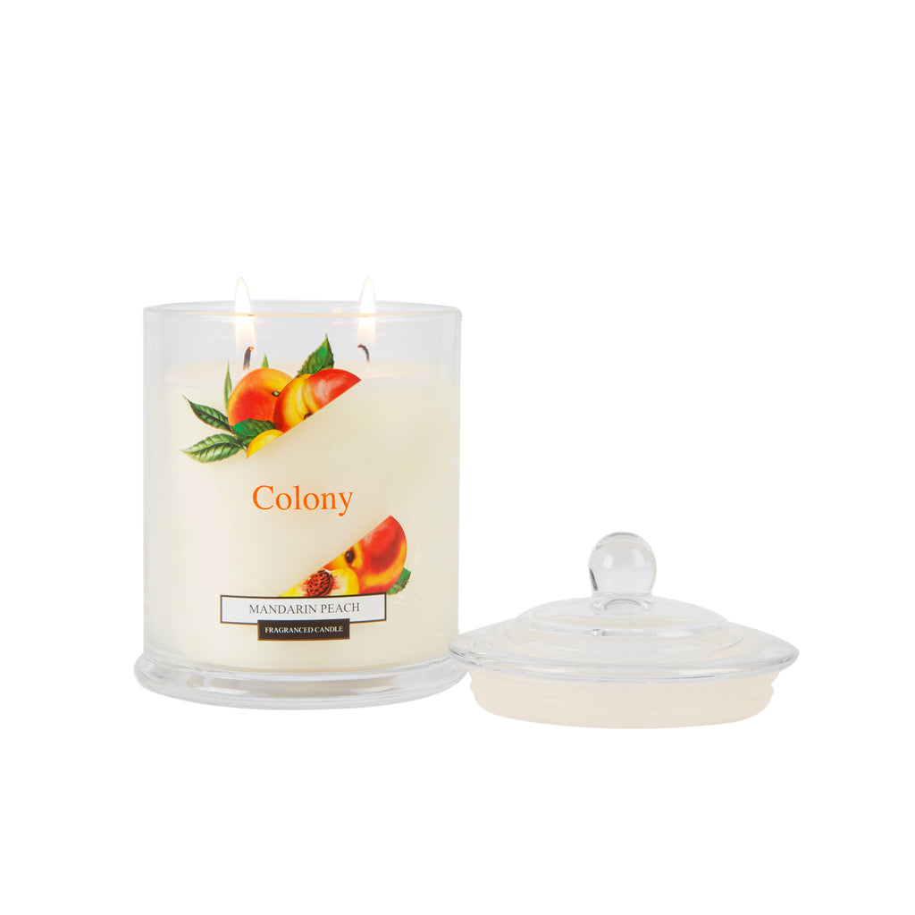 Wax Lyrical Colony Mandarin Peach Medium Candle. Mandarin, peach together with zesty lime, earthy basil, fresh lemongrass in this fruit bowl fragrance. Spearmint and moss and vetivert base create a scented base. 