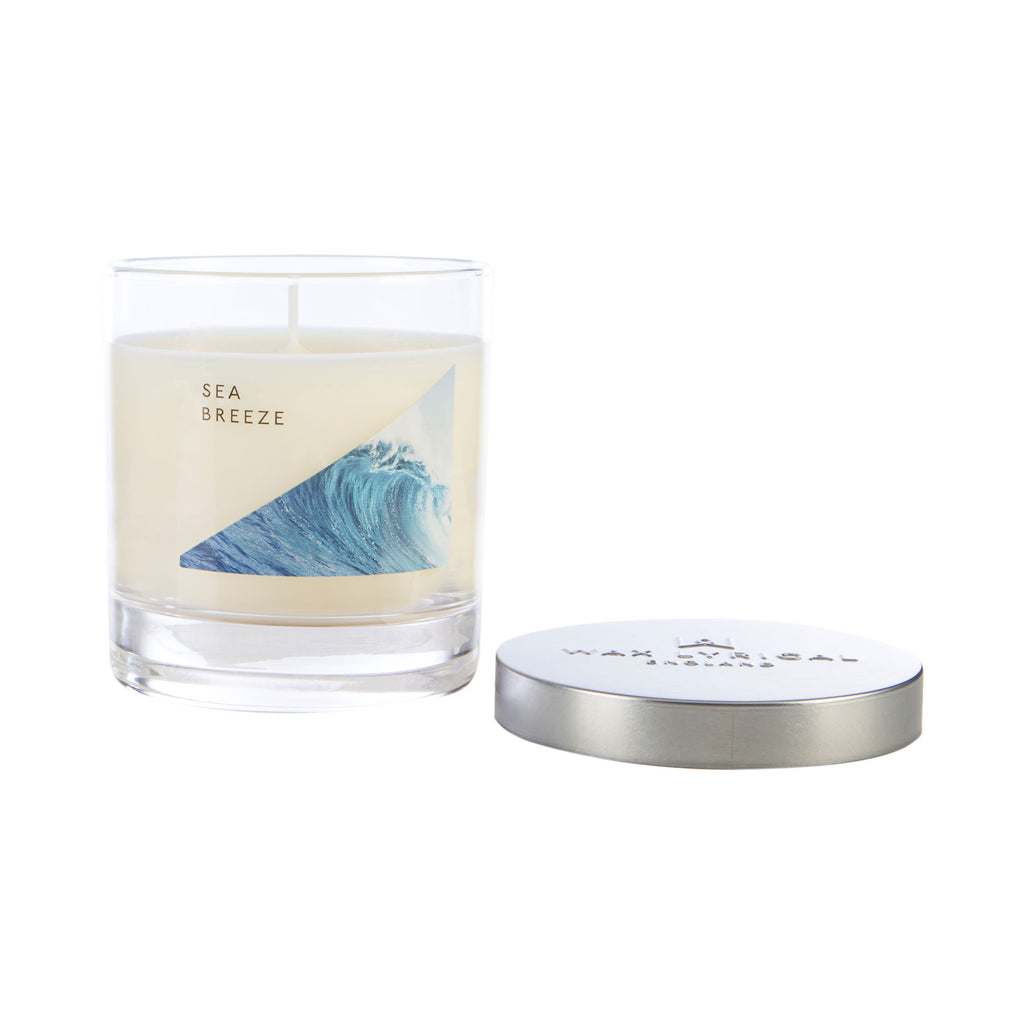 Wax Lyrical Made In England Sea Breeze Medium Tin Candles. A refreshing fragrance bringing watery notes to your home. A floral heart, fresh figs and woody notes, amber and musk.