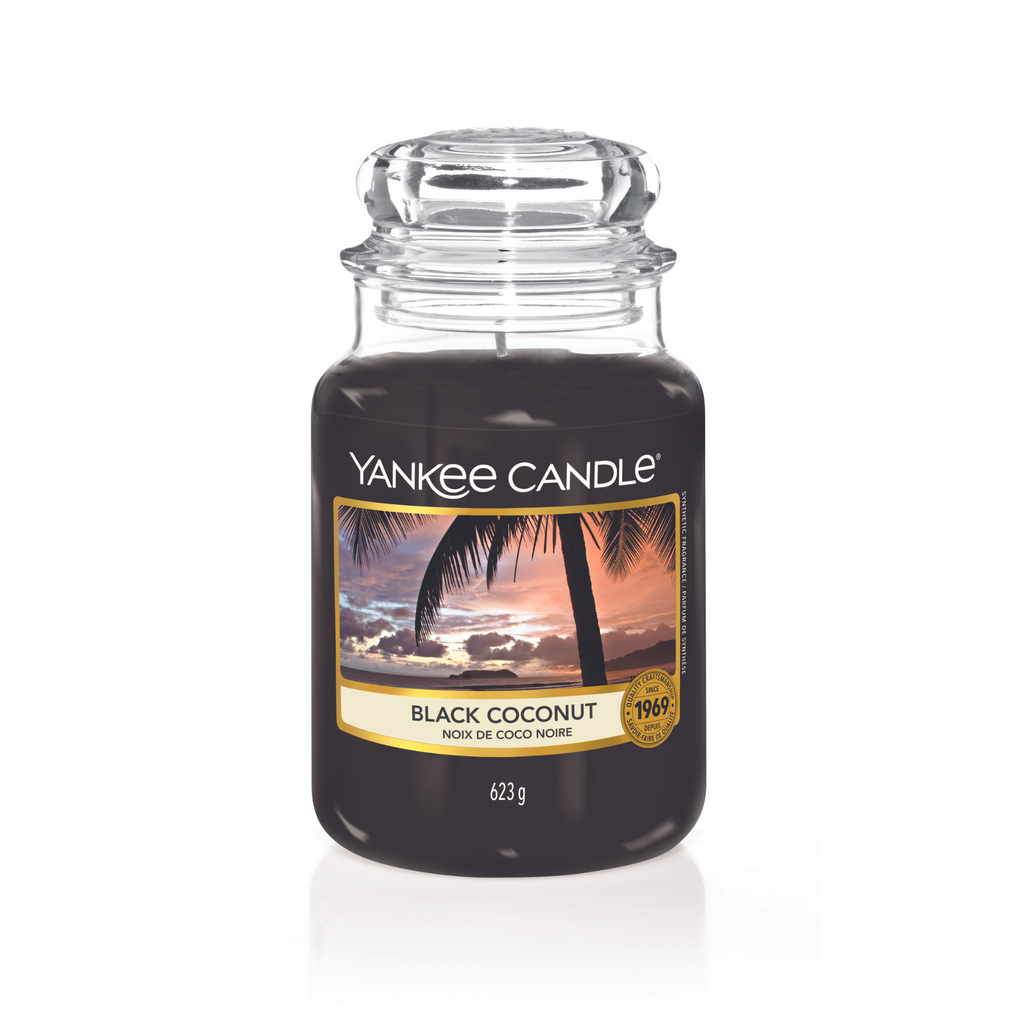 Yankee Candle Black Coconut Large Jar Candle. Notes of rich coconut, cedarwood and island blossoms promise a relaxing evening of luxurious calm tranquillity
